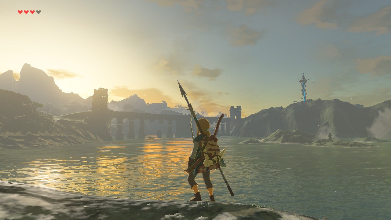 A screenshot of Breath of the Wild, with Link looking out over a sunrise above a bridge over a lake.